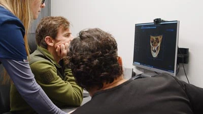 Dr. Burk showing a patient their 3d x-ray of their teeth