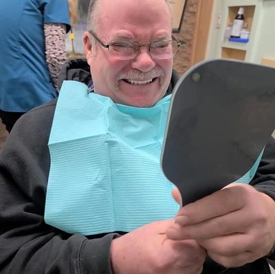 Take 2 Dental Implant Studio patient smiling big after injections removed his TMJ pain
