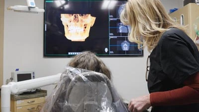 patient being shown her dental x-rays at Take 2 Dental Implant Studio