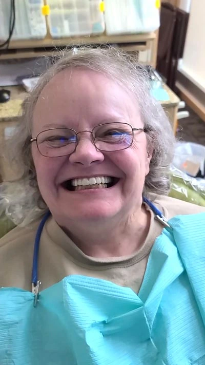 woman smiling showing off her newly restored smile